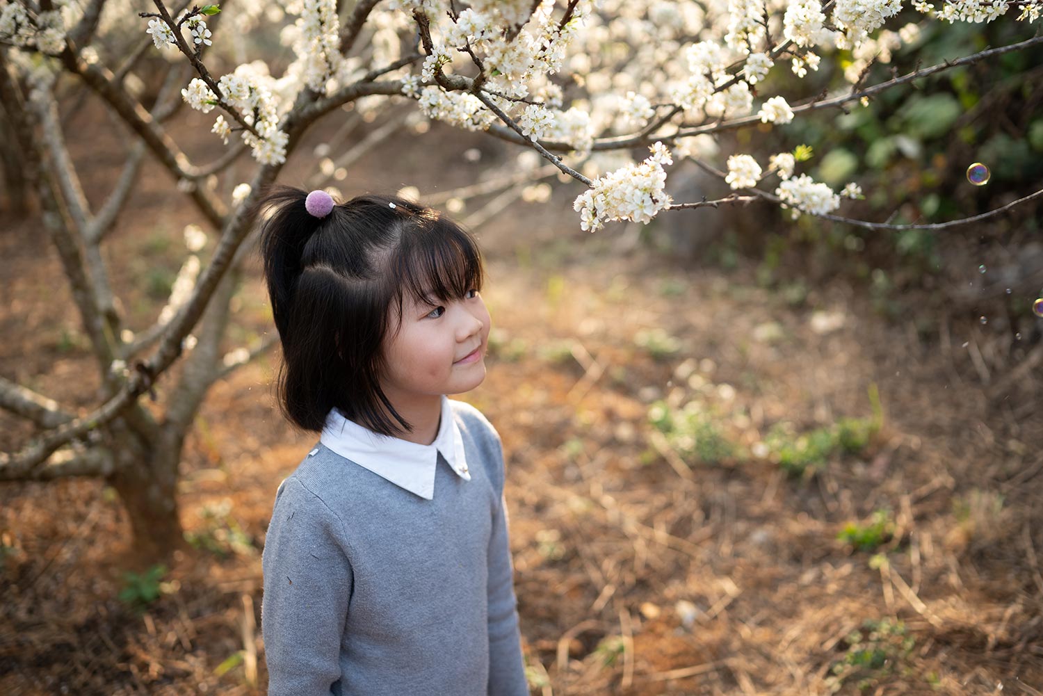 Girl in front of blossoms